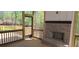 This screened-in porch has a brick fireplace and wooden railing, ideal for relaxing and enjoying the beautiful outdoor view at 4525 Aiden Way, Cumming, GA 30041