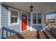 Front porch of a charming blue house with a red door at 521 Martin Se St, Atlanta, GA 30312