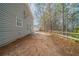 View of a backyard with a wooden fence and trees at 7110 Ravenwood Ln, Lithonia, GA 30038