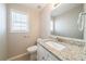 Small bathroom with granite countertop and toilet at 7110 Ravenwood Ln, Lithonia, GA 30038