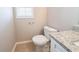 Simple bathroom with toilet and granite vanity at 7110 Ravenwood Ln, Lithonia, GA 30038