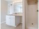 Bathroom featuring granite countertop, white cabinets, and shower at 7110 Ravenwood Ln, Lithonia, GA 30038