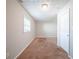 Well-lit bedroom with neutral walls and carpet flooring at 7110 Ravenwood Ln, Lithonia, GA 30038