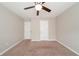 Bedroom with ceiling fan, neutral walls, and carpet at 7110 Ravenwood Ln, Lithonia, GA 30038