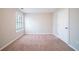 Bright bedroom with neutral walls, carpeting, and window at 7110 Ravenwood Ln, Lithonia, GA 30038