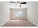 Bedroom with ceiling fan, window, and neutral carpet at 7110 Ravenwood Ln, Lithonia, GA 30038