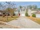 Two-story house with a red door and driveway at 7110 Ravenwood Ln, Lithonia, GA 30038