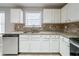 White kitchen cabinets and granite countertops at 7110 Ravenwood Ln, Lithonia, GA 30038