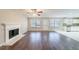 Living room with hardwood floors, fireplace and access to kitchen at 7110 Ravenwood Ln, Lithonia, GA 30038