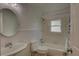 Clean bathroom with a tub and shower combo, updated vanity, and neutral tile floors at 410 Sycamore Se St, Marietta, GA 30060