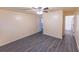 Spacious bedroom with grey flooring, ceiling fan and access to bathroom at 417 Ridge Creek Dr, Clarkston, GA 30021