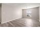 Well-lit bedroom featuring grey vinyl flooring and a window at 175 Rue Fontaine, Lithonia, GA 30038