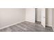 Bright bedroom with grey vinyl flooring and an open door to hallway at 175 Rue Fontaine, Lithonia, GA 30038