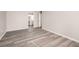 Spacious bedroom with grey wood-look floors and an ensuite bathroom at 175 Rue Fontaine, Lithonia, GA 30038