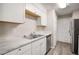 Updated kitchen featuring white cabinets and a marble countertop at 175 Rue Fontaine, Lithonia, GA 30038