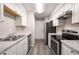 Modern kitchen with stainless steel appliances and white cabinets at 175 Rue Fontaine, Lithonia, GA 30038