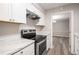 Modern kitchen features stainless steel appliances and white cabinets at 175 Rue Fontaine, Lithonia, GA 30038