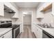Eat-in kitchen with stainless steel appliances and view to dining area at 175 Rue Fontaine, Lithonia, GA 30038