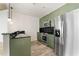 Modern kitchen with green cabinets and stainless steel appliances at 400 W Peachtree Nw St # 2313, Atlanta, GA 30308