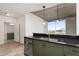 Modern kitchen with green cabinets and stainless steel appliances at 400 W Peachtree Nw St # 2313, Atlanta, GA 30308