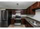 Stainless steel appliances and dark brown cabinets in this updated kitchen at 5277 Brentwood Rd, Atlanta, GA 30349