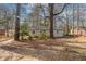 House surrounded by trees in a large backyard at 667 Steve Sw Dr, Atlanta, GA 30315