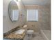 Updated bathroom with granite countertop and tiled shower at 667 Steve Sw Dr, Atlanta, GA 30315