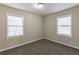 Well-lit bedroom with two windows and neutral walls at 667 Steve Sw Dr, Atlanta, GA 30315