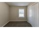 Cozy bedroom with a window, closet, and neutral decor at 667 Steve Sw Dr, Atlanta, GA 30315