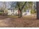 Ranch style home with mature trees and a red front door at 667 Steve Sw Dr, Atlanta, GA 30315