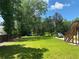 Large grassy backyard with wooden fence and mature trees at 1886 Clay Sw Dr, Marietta, GA 30064