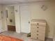 Basement area featuring a white door and light wood dresser against a beige wall at 1886 Clay Sw Dr, Marietta, GA 30064