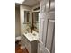 Bathroom showcases a white sink, framed mirror, and neutral-toned walls at 1886 Clay Sw Dr, Marietta, GA 30064