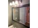 Bathroom mirror reflecting a sink, faucet, framed art and door at 1886 Clay Sw Dr, Marietta, GA 30064