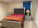 Bedroom with modern furnishings including bed, mirrored nightstands, and dark curtains at 1886 Clay Sw Dr, Marietta, GA 30064