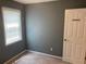 Neutral bedroom features carpet, grey walls, a window, and white door at 1886 Clay Sw Dr, Marietta, GA 30064