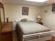 Bedroom boasts a bed with white headboard, dresser, and neutral-toned walls at 1886 Clay Sw Dr, Marietta, GA 30064