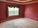 This bedroom features neutral carpeting, and a large window with curtains at 1886 Clay Sw Dr, Marietta, GA 30064