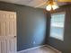 Comfortable carpeted bedroom with ceiling fan and a sunny window at 1886 Clay Sw Dr, Marietta, GA 30064
