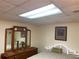 Bedroom area with white headboard and dresser, illuminated by fluorescent lighting at 1886 Clay Sw Dr, Marietta, GA 30064