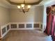 Traditional dining room with paneled walls, classic chandelier, and ample space for entertaining at 1886 Clay Sw Dr, Marietta, GA 30064