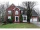 Brick two-story house with attached garage and landscaped lawn at 1886 Clay Sw Dr, Marietta, GA 30064