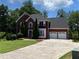 Charming two-story brick home with well-maintained landscaping, two car garage and a spacious driveway at 1886 Clay Sw Dr, Marietta, GA 30064