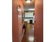Hallway view leading to a kitchen with white cabinets, modern appliances, and wood-style flooring at 1886 Clay Sw Dr, Marietta, GA 30064