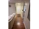 Hallway with wood floors leads to a white door and wainscoting at 1886 Clay Sw Dr, Marietta, GA 30064