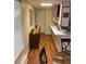 Hallway features wood-look floors, leading to the kitchen and a white door at 1886 Clay Sw Dr, Marietta, GA 30064
