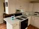 Kitchen with gas range, microwave and white cabinets at 1886 Clay Sw Dr, Marietta, GA 30064