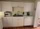 Bright kitchen with white cabinets, stainless steel appliances and wood-look floors at 1886 Clay Sw Dr, Marietta, GA 30064