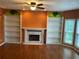 Spacious living room with hardwood floors, a fireplace, built-in bookshelves, and plenty of natural light at 1886 Clay Sw Dr, Marietta, GA 30064
