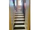 Elegant staircase featuring dark wood steps and decorative metal railing leading to a light-filled foyer at 1886 Clay Sw Dr, Marietta, GA 30064